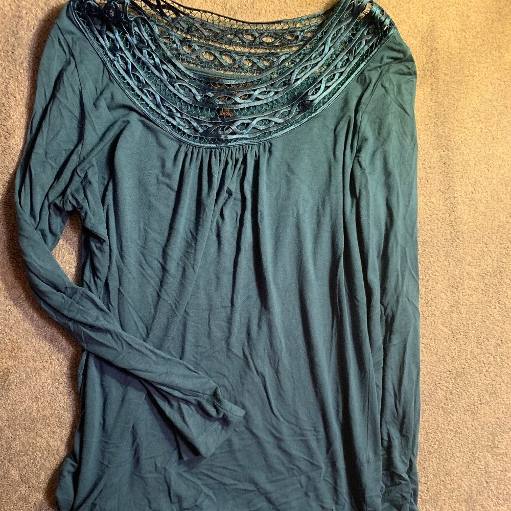 Boat-neck blue top with fun design around opening